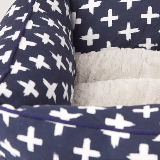 Navy blanket with white cross pattern and grey fleece lining