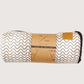 Folded double car seat cover with wavy pattern and packaging on a white background
