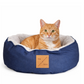 Cat lying in a blue pet bed with a visible brand label on a white background