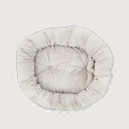 Round pet bed with a soft texture on a light gray background