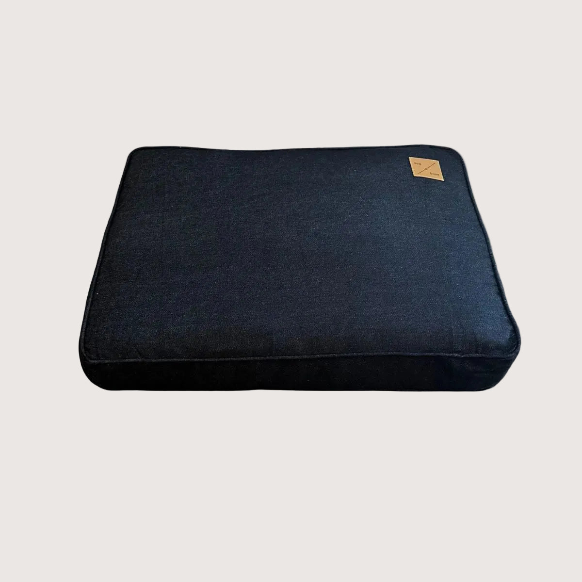 dark black denim dog bed with a brand logo on a white background