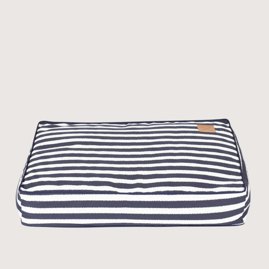 Navy and white striped pet bed on a white background