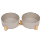 Beige pet bowls with bamboo stand on a white background