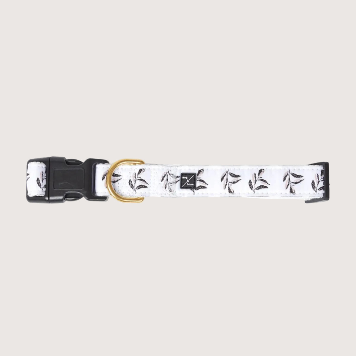 Dog collar with black and pink leaf pattern on a white background