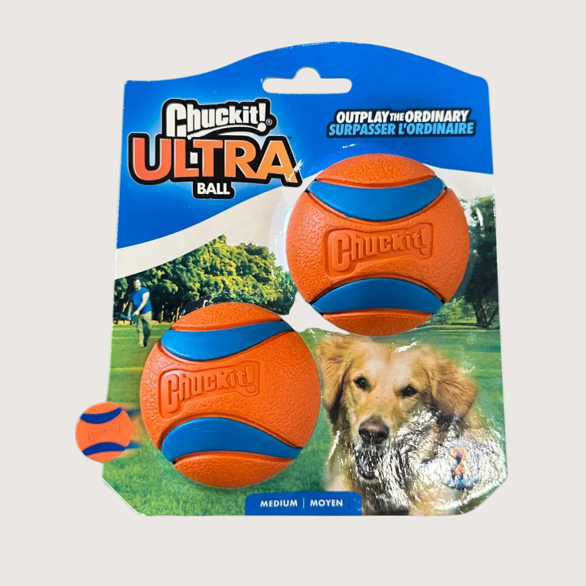 Chuckit! Ultra Ball dog toy packaging with two balls on a grassy field background.