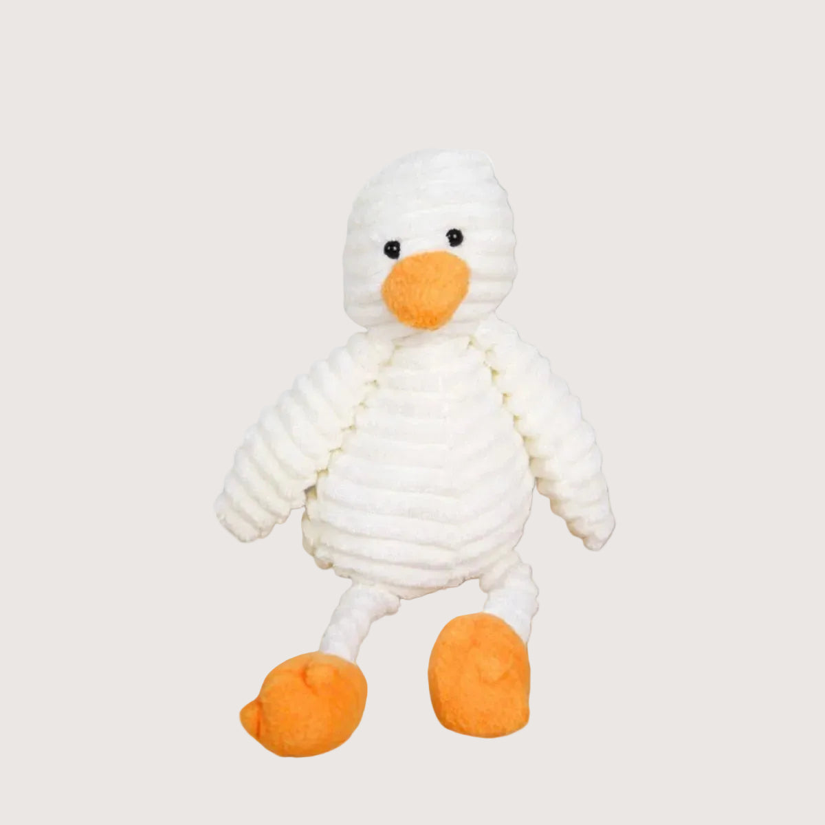 White plush duck toy with orange feet and beak on a light gray background