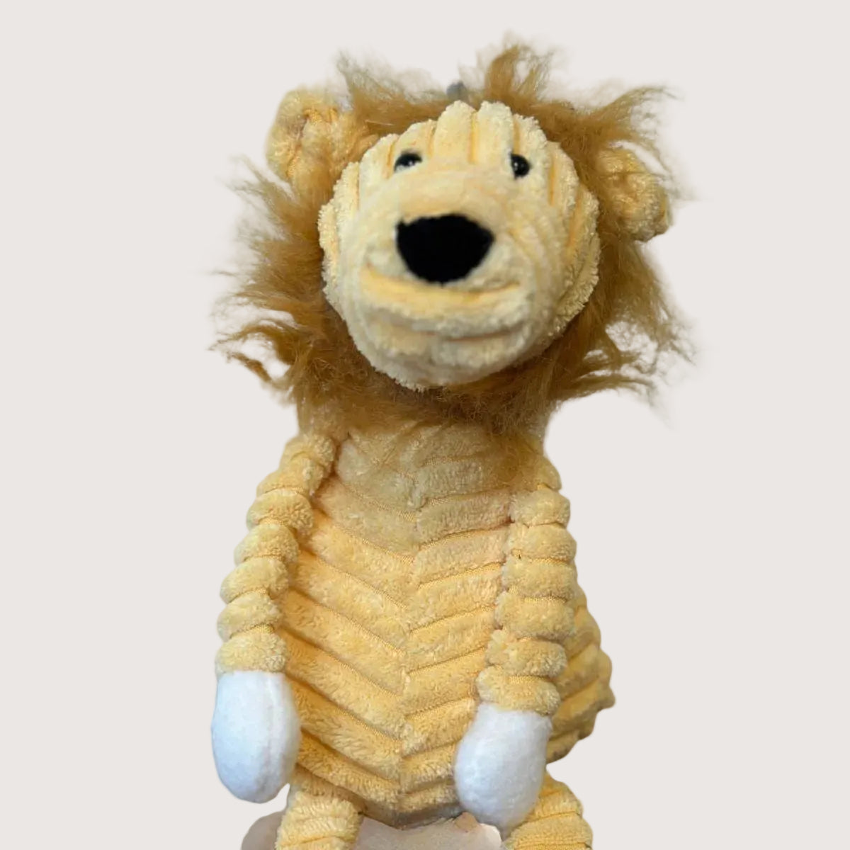 Plush lion toy on a white background