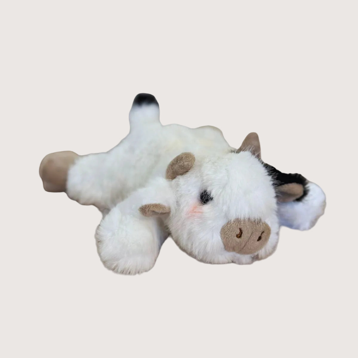 Plush cow dog toy on a white background